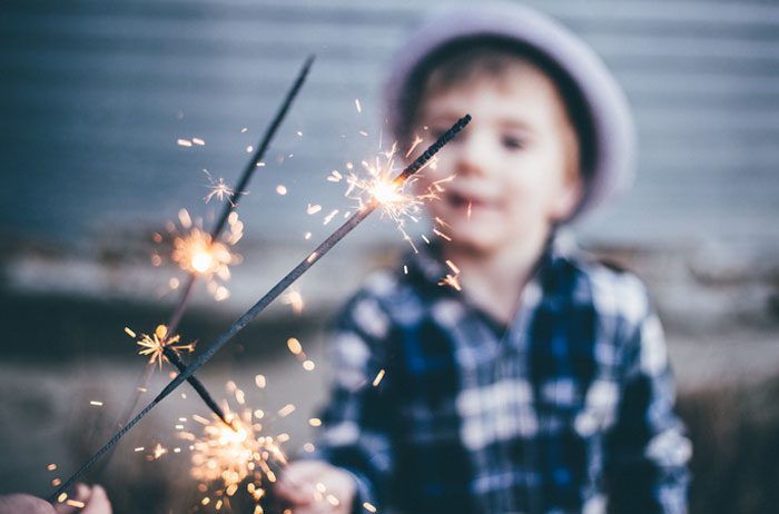 Children playing with sparklers.