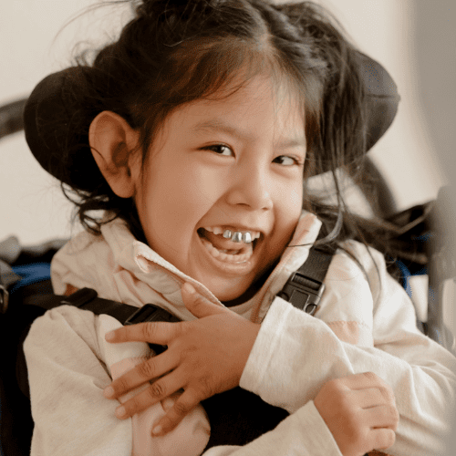 Young girl with a disability laughs